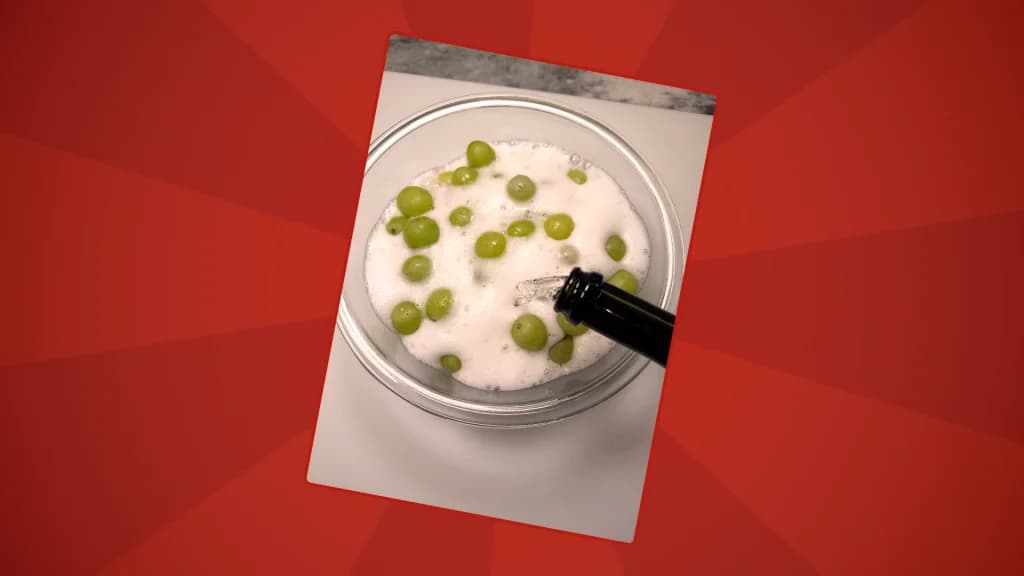 Grapes are in a bowl with prosecco poured over them