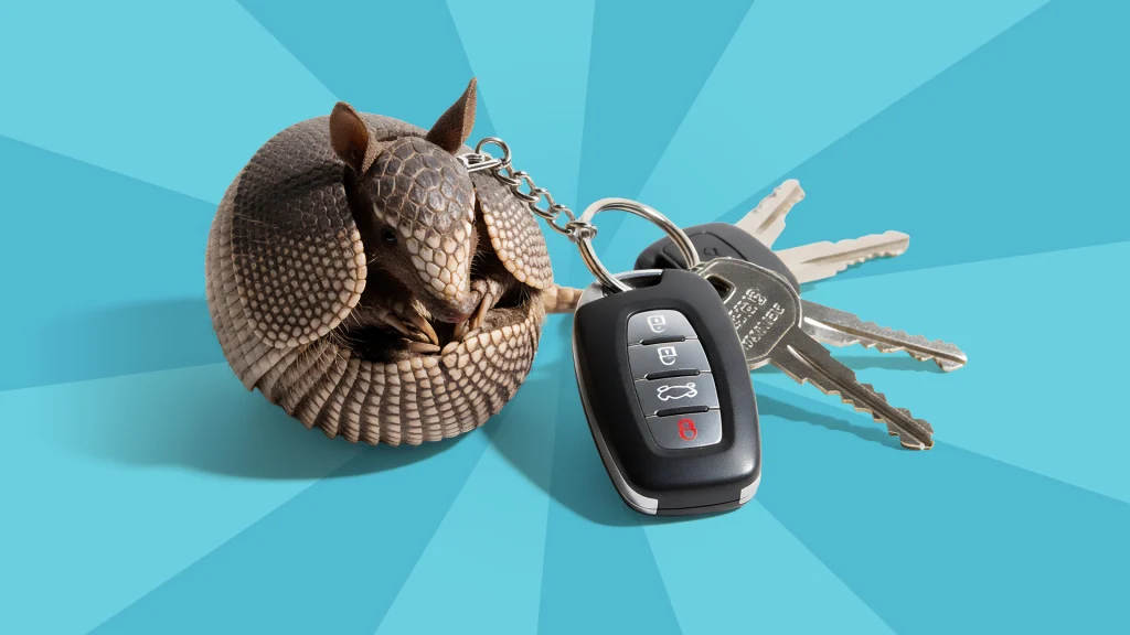 an armadillo attached to a keychain with car keys on a blue background