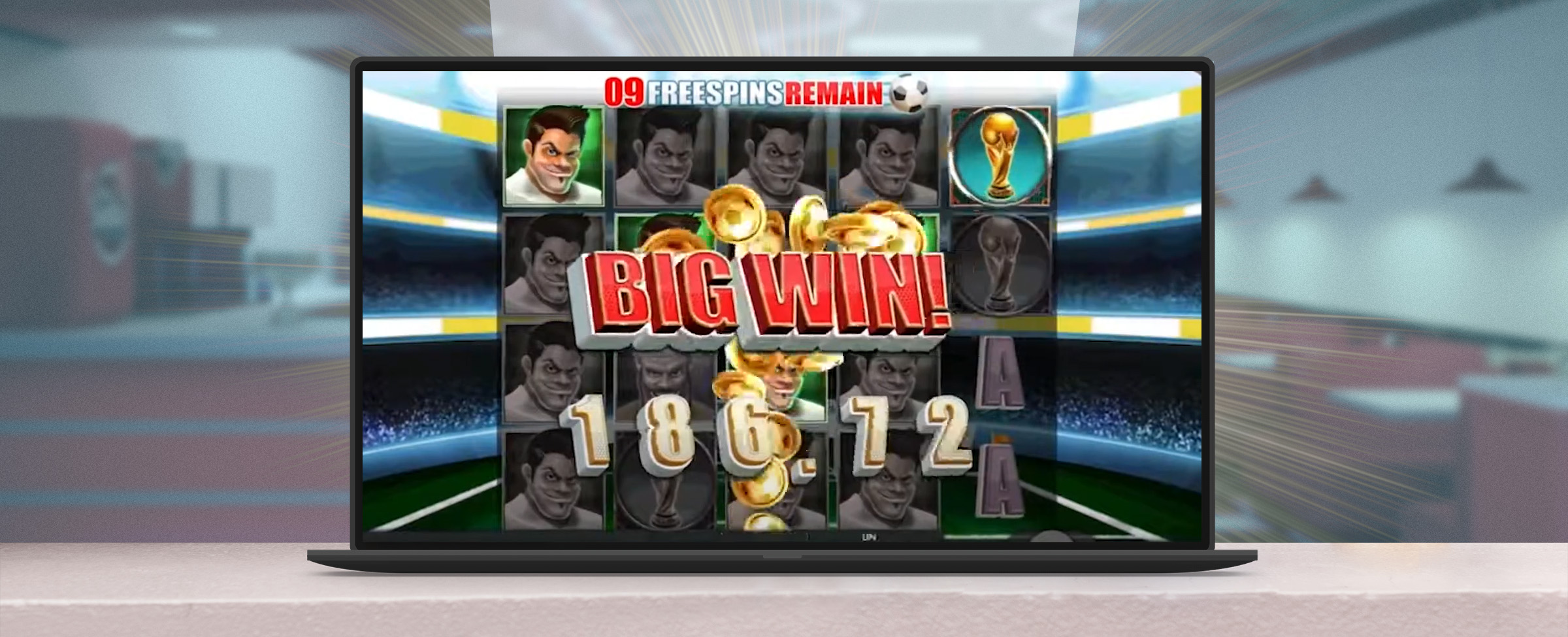 A laptop sits on a counter top of an out-of-focus American diner, previewing a screenshot of the gameplay of the Cafe Casino slot ‘World Cup Football’, with the words “Big Win” accompanied by 186.72, indicating the amount won.
