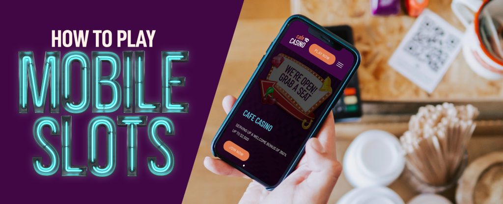 An image of a cafe table in the background, with a hand in the foreground holding up a mobile phone showing the Cafe Casino website, while on the left, a mostly neon sign reads “How to play mobile slots”.