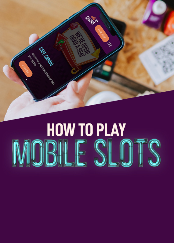 A mobile phone being held by a person’s hand is seen in the foreground, showing a screenshot of Cafe Casino’s website, while below, a mostly neon sign reads “How to play mobile slots”. In the background, is an out-of-focus cafe table.