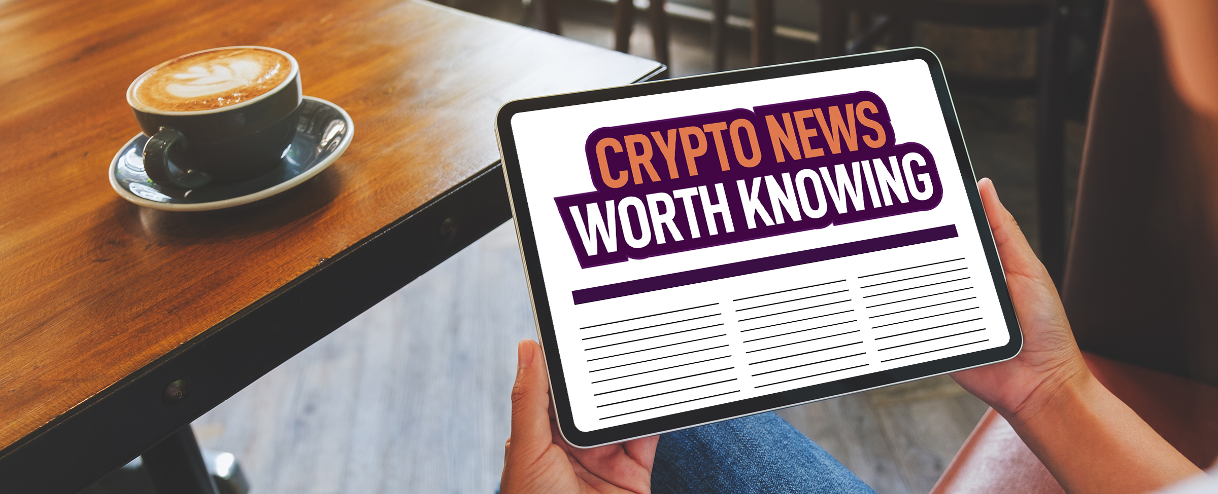 A person sits on a bench seat inside a diner, holding up an iPad that shows a news site with a heading that reads “Crypto News Worth Knowing”. Next the bench seat is a wooden table, with a black coffee mug with a cafè latte, on a black saucer.