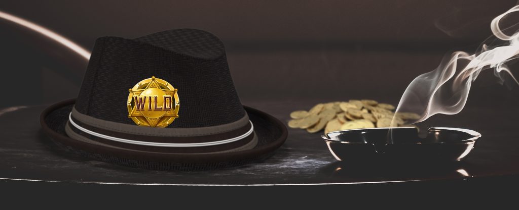A black fedora-style hat with a gold sheriff’s badge tucked into a gray band sits atop a black table, with a pile of gold coins to its right, and a black, smoking ashtray below.