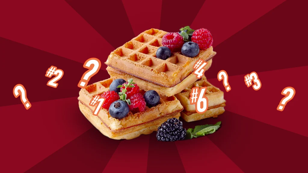 Three freshly cooked waffles sit in a stack, with blueberries, raspberries and blackberries scattered over them, with a mint leaf to the side. Surrounding them are the numbers 1, 4, and 6, with two question marks appearing either side. Behind we see a duo-toned red and maroon background.