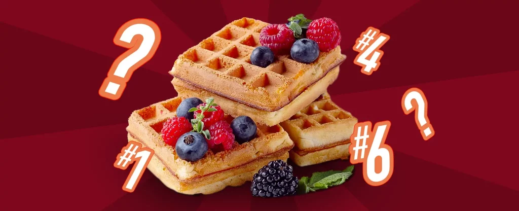 Three freshly cooked waffles sit in a stack, with blueberries, raspberries and blackberries scattered over them, with a mint leaf to the side. Surrounding them are the numbers 1, 4, and 6, with two question marks appearing either side. Behind we see a duo-toned red and maroon background.