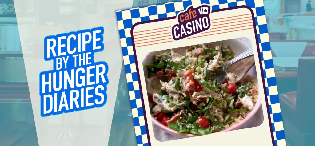 A mixed green salad with chicken salad, quinoa and cherry tomatoes peeking out; overlaid with the words “Recipe By The Hunger Diaries” in blue font.