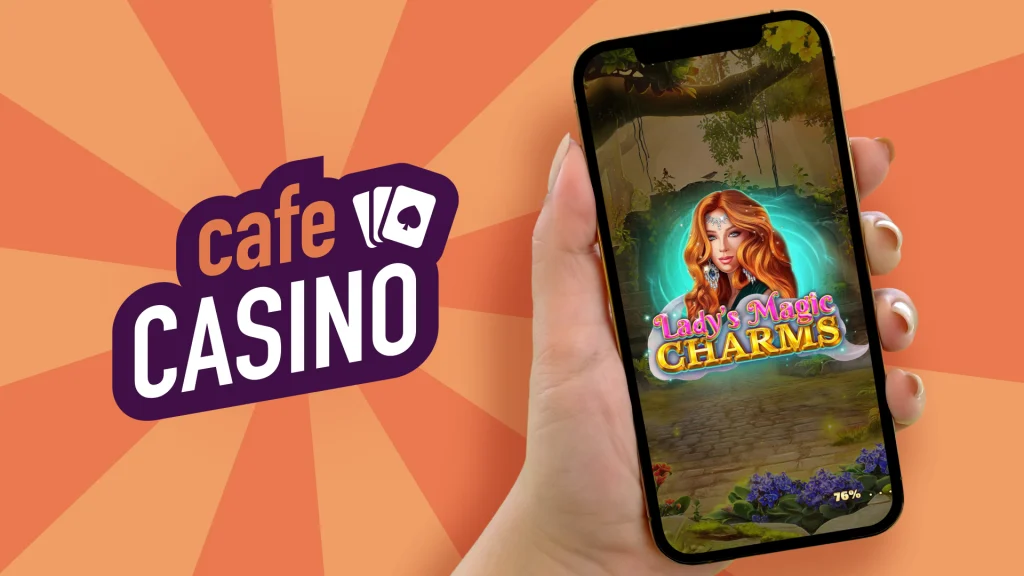 A hand holds out a mobile phone showing a screenshot from a Cafe Casino slot game alongside its logo, set against an orange and apricot background.
