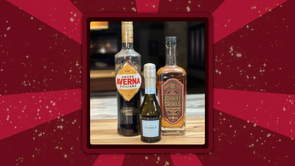 Bottles of Johnny Drinks Rum, Averna, and Prosecco stand in a row on a wooden cutting board.