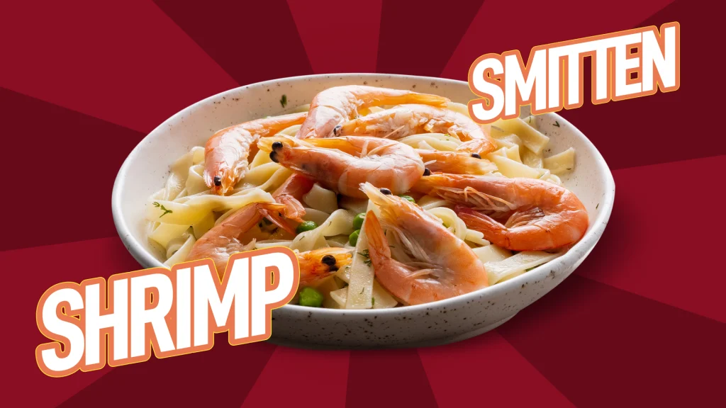 Shrimp with garlic butter pasta in a white bowl on a red background, with the words SHRIMP and SMITTEN overlaid.