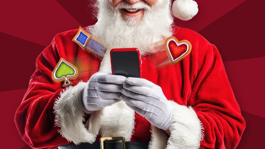 Santa smiles and holds a red phone with playing card symbols emerging from the screen.