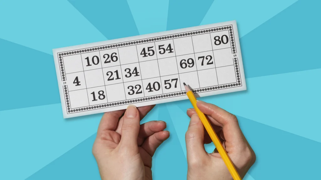 Two hands are holding up a white keno card with numbers on a light blue image, and one hand is about to circle a number.