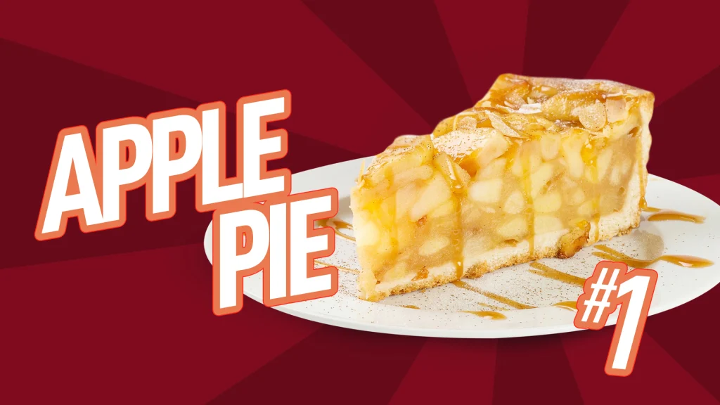 On a red Cafe Casino background is a white plate with a slice of apple pie and text that says ‘APPLE PIE’ and the number one on the bottom right.